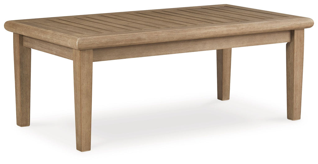 Rectangular cocktail table, beige wood top with tapered legs and squared edges.