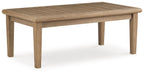 Rectangular cocktail table, beige wood top with tapered legs and squared edges.
