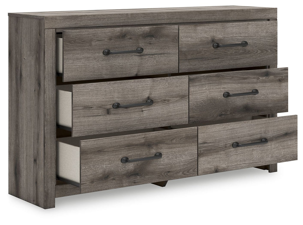 Six-drawer dresser with gray-brown wood finish and black bar pulls, drawers partially open