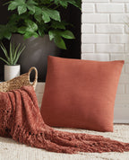 Square throw pillow, coral-red fabric with stitched edge
