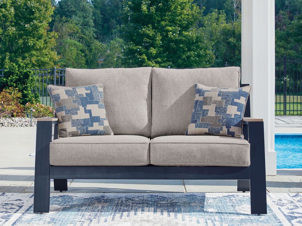 Blue patterned loveseat with gray seat cushions and dark frame