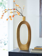 Gold vase holding orange blossoms with tall oval opening