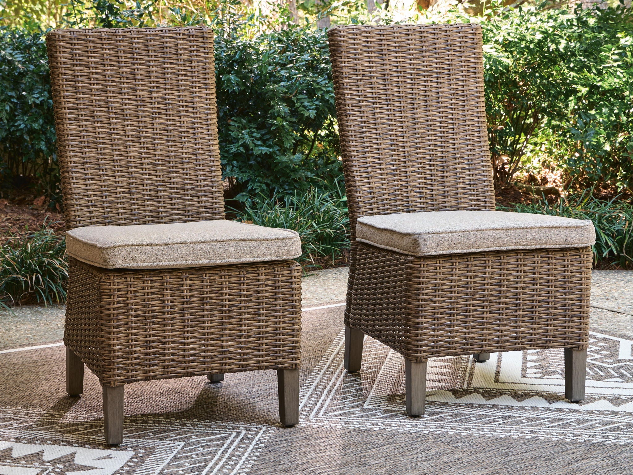 Pair of beige woven side chairs with thick seat cushions on square tapered legs