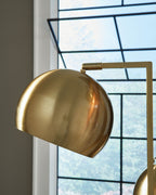 Gold dome-style lamp shade with a visible bulb opening and metal arm