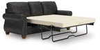 Dark gray sofa sleeper with pull-out mattress base and tufted back cushions