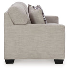 Pebble sofa sleeper side view with a patterned accent pillow and rounded arms