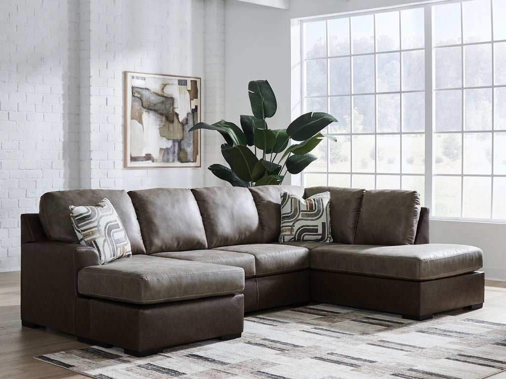 Dark fossil sectional sofa with chaise corner and three gray patterned accent pillows