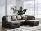 Dark fossil sectional sofa with chaise corner and three gray patterned accent pillows