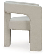Light beige upholstered accent chair with curved side arms and block legs