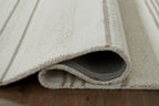Off-white rug with beige stripes and gray underside backing