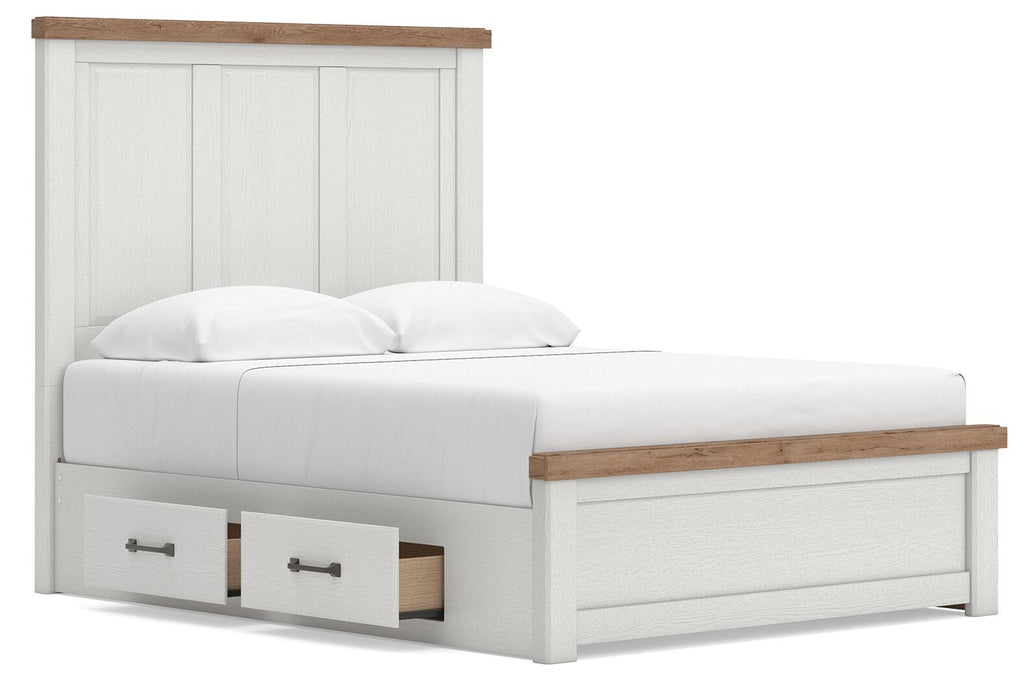 White panel storage bed with wood-trim headboard and two under-bed drawers, angled side view