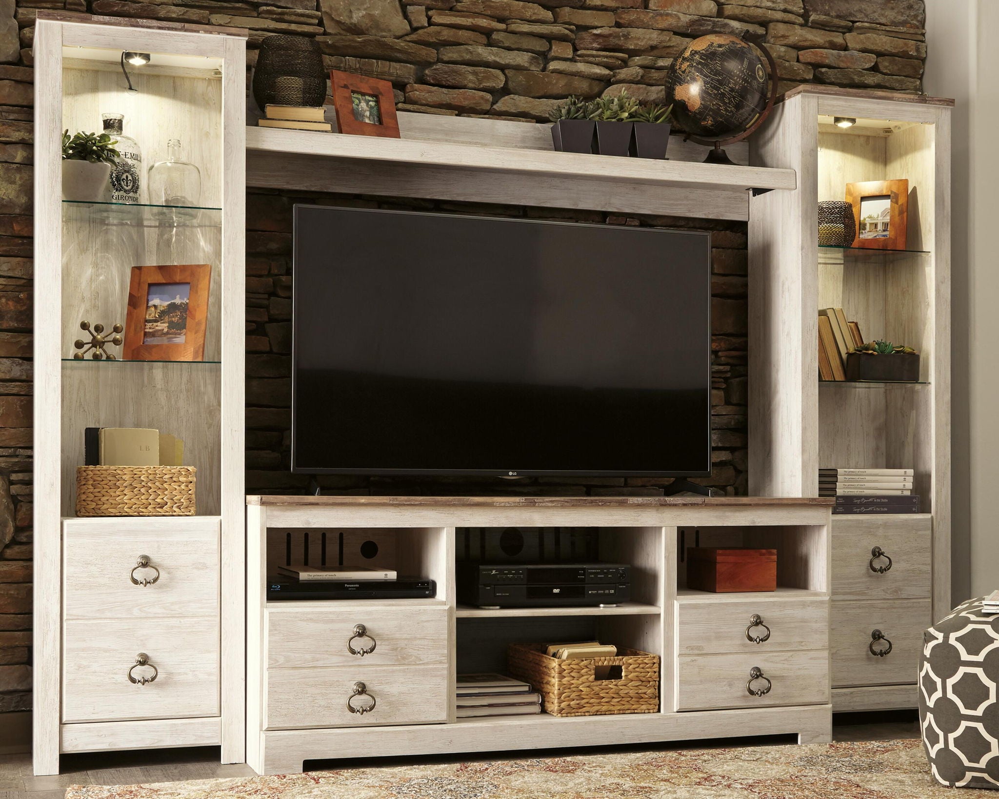 Beige entertainment center with open shelves, drawers, and TV media center