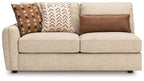 Sand LAF sofa with light beige upholstery and three decorative pillows, wide seat cushions.