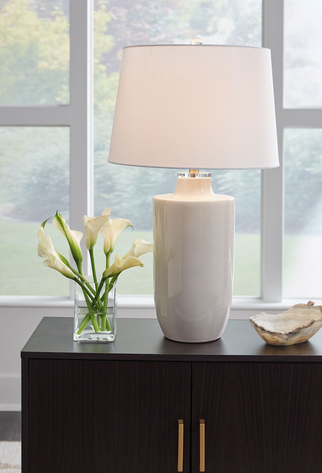 Off-white ceramic table lamp with drum shade and cylindrical base