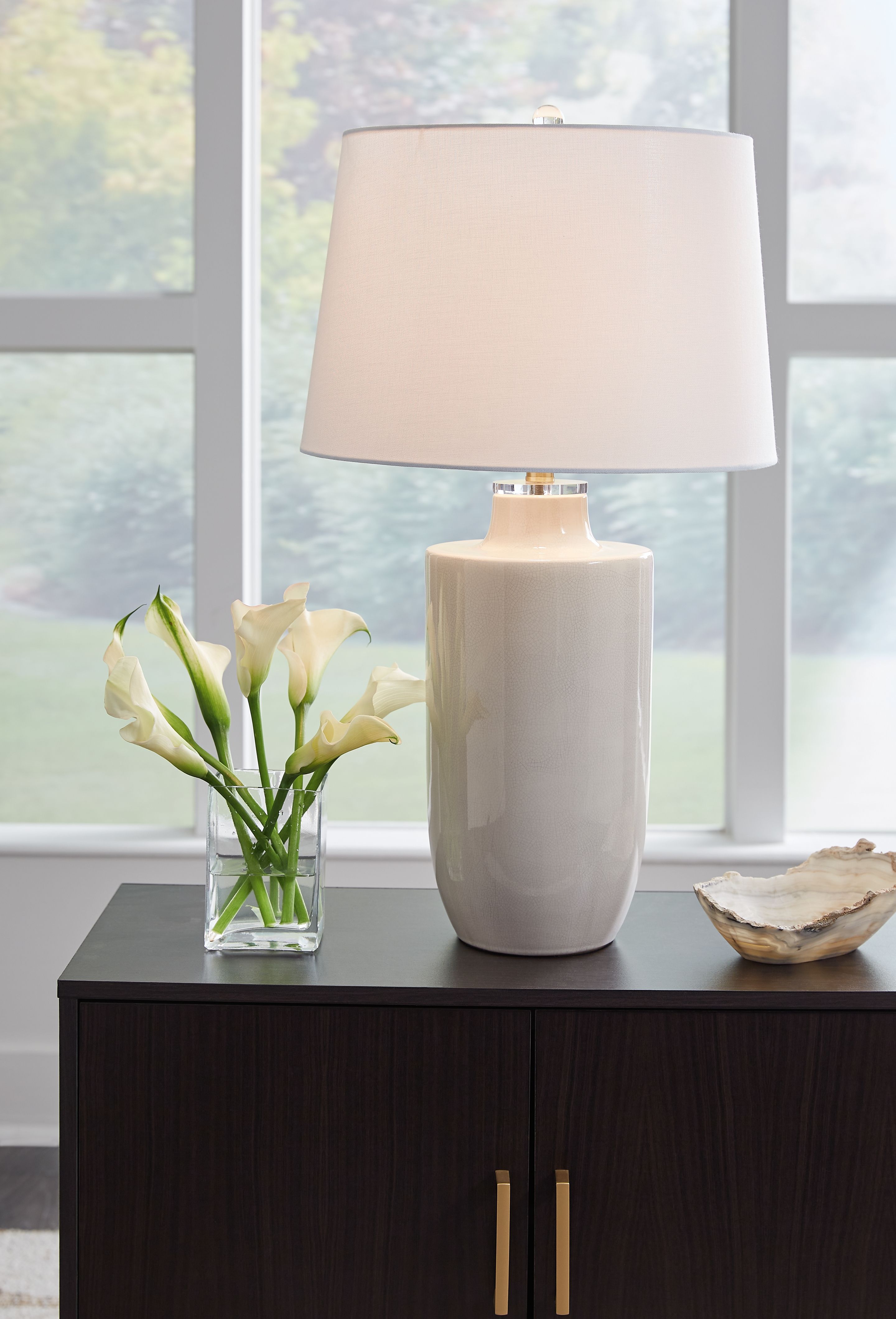 Off-white ceramic table lamp with drum shade and cylindrical base