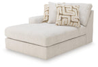 Light beige corner chaise sectional with left-facing arm and two patterned throw pillows