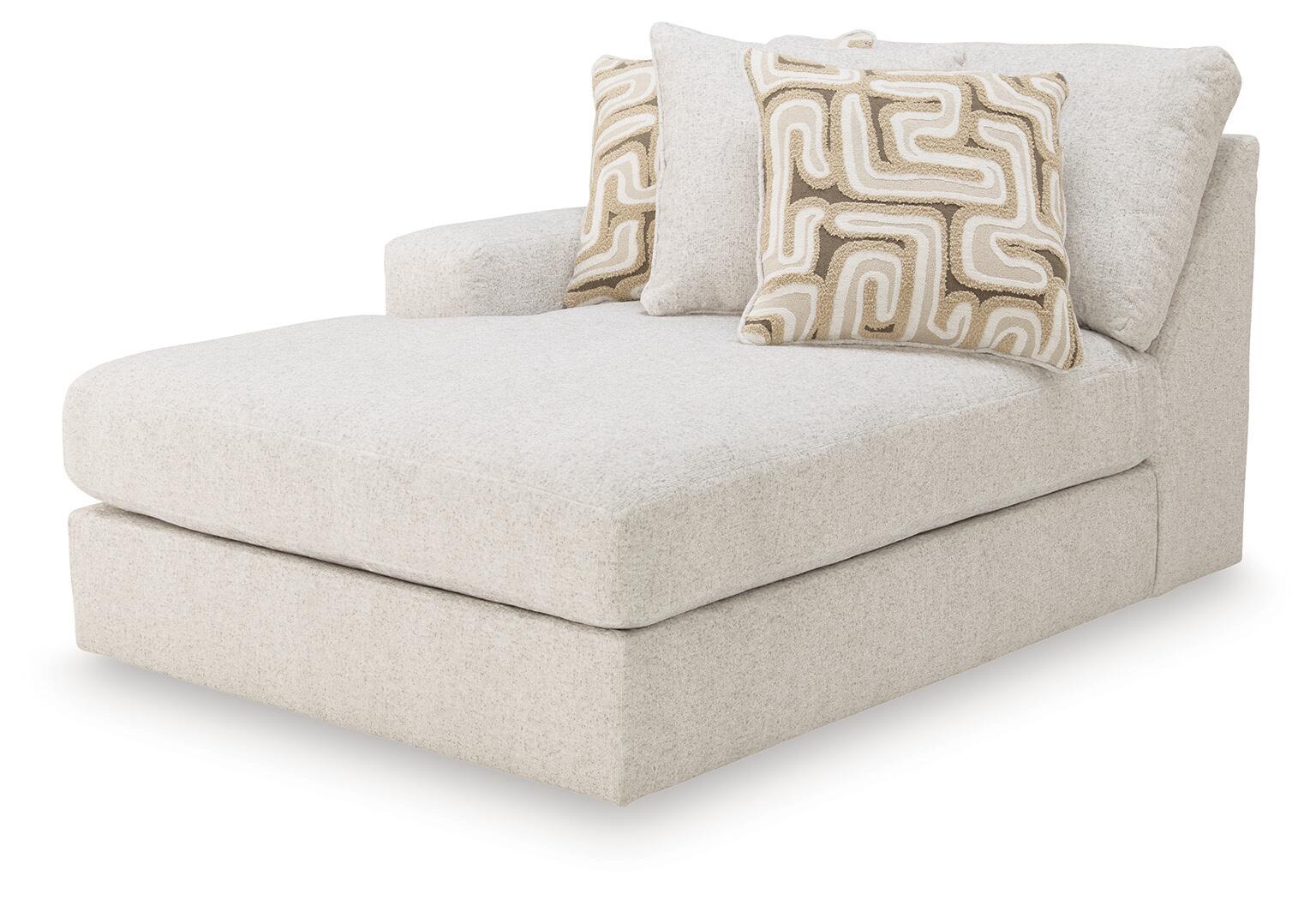 Light beige corner chaise sectional with left-facing arm and two patterned throw pillows