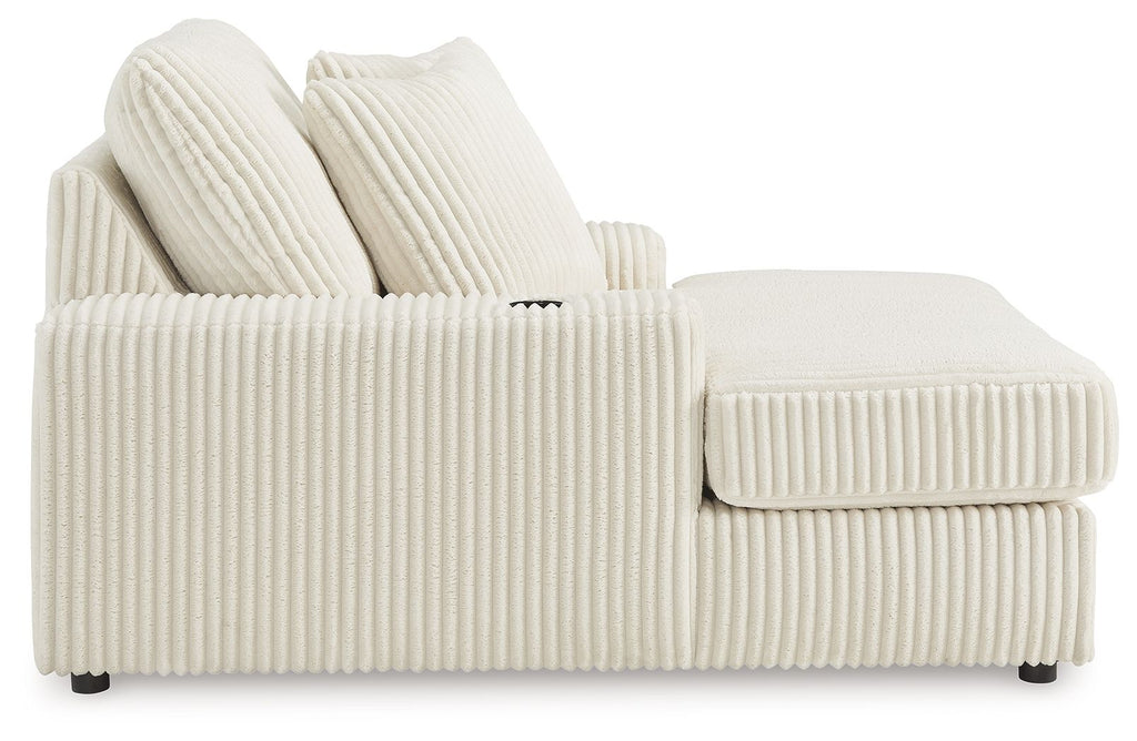 Corduroy chaise lounge chair in off-white with side arm panel and two back cushions.