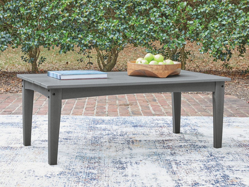 Gray outdoor cocktail table with slatted top, holding a fruit tray