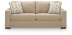 Sofa sleeper front view in light tan fabric with two patterned pillows