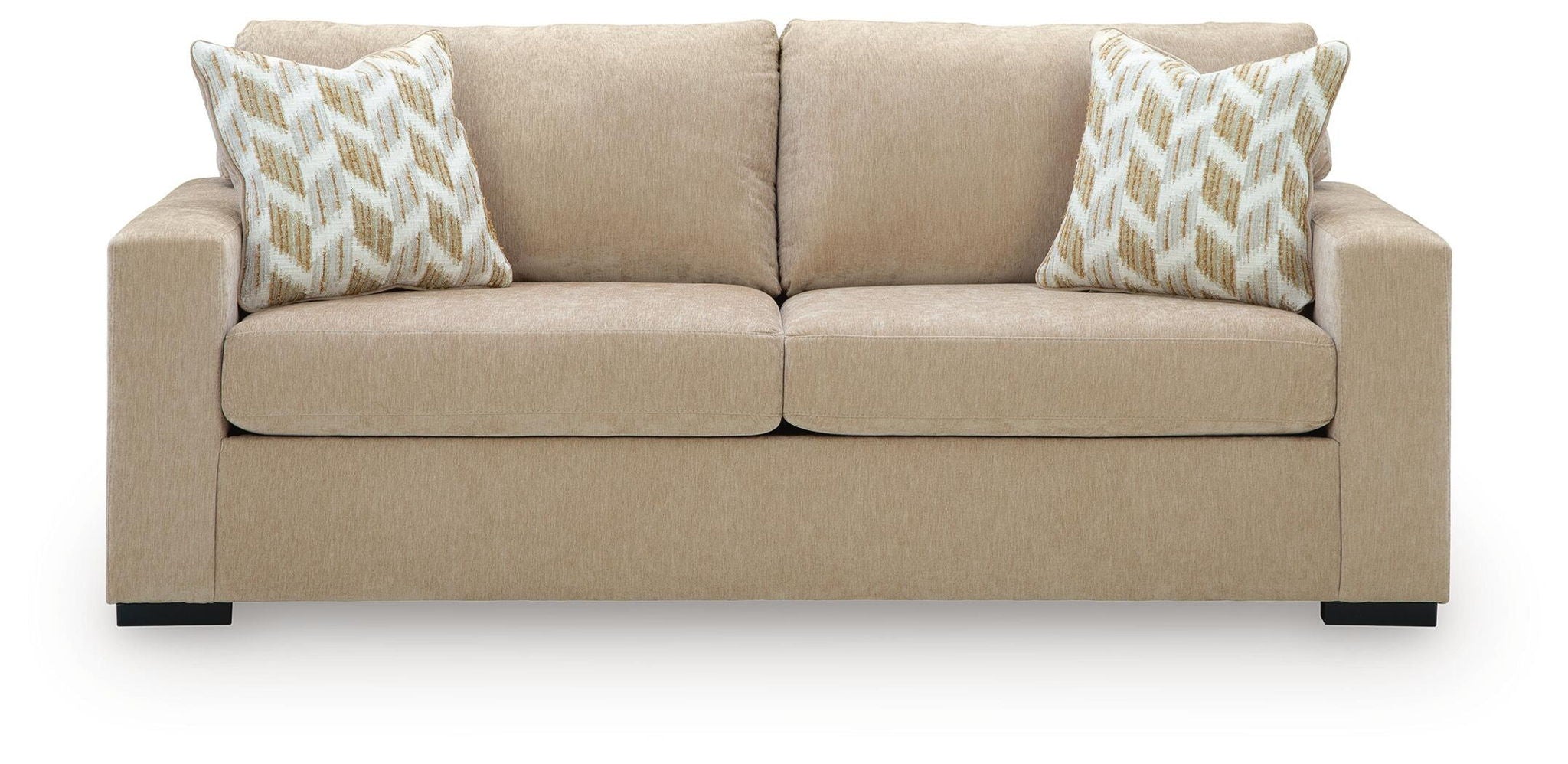 Sofa sleeper front view in light tan fabric with two patterned pillows