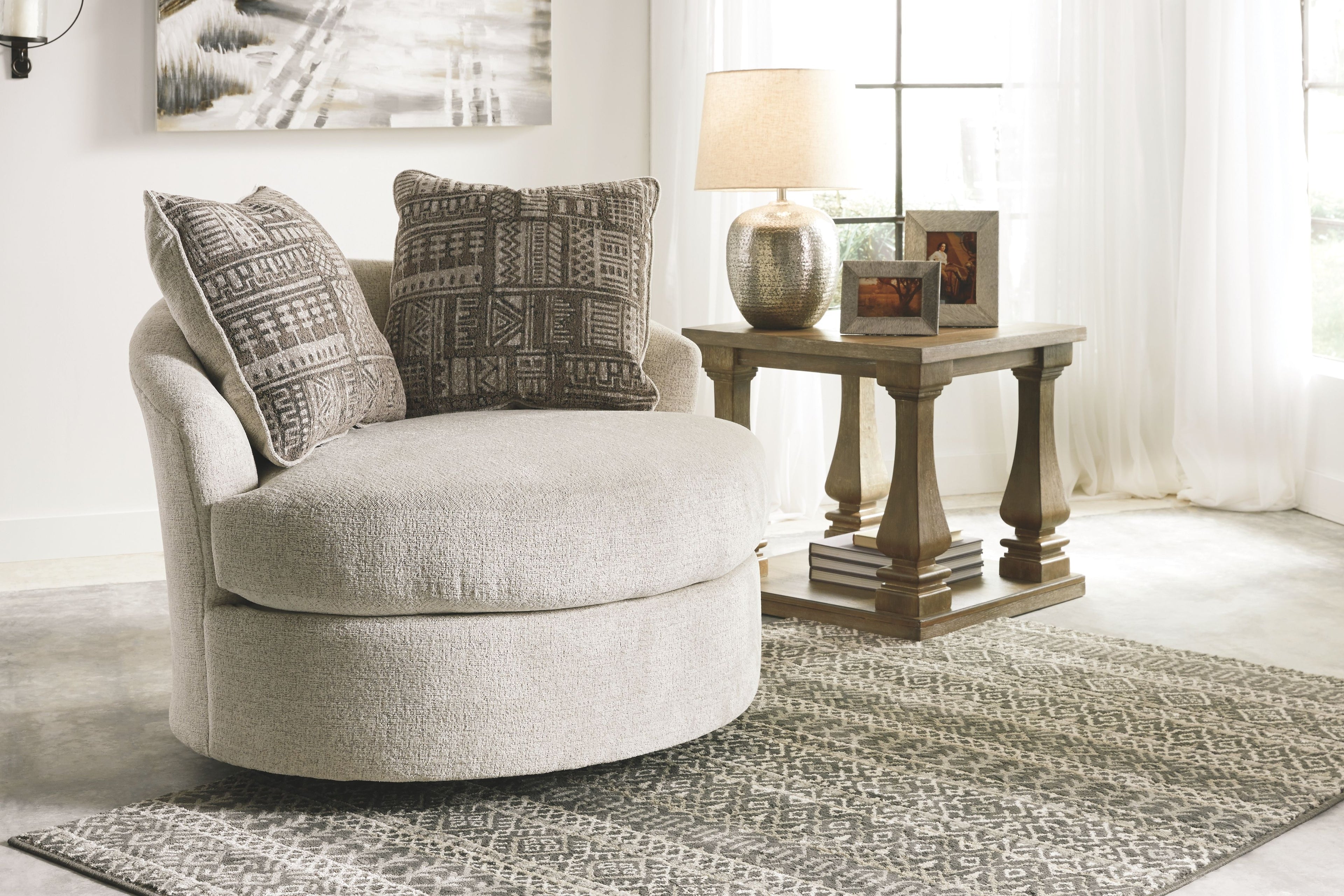 Beige fabric accent chair with patterned throw pillows