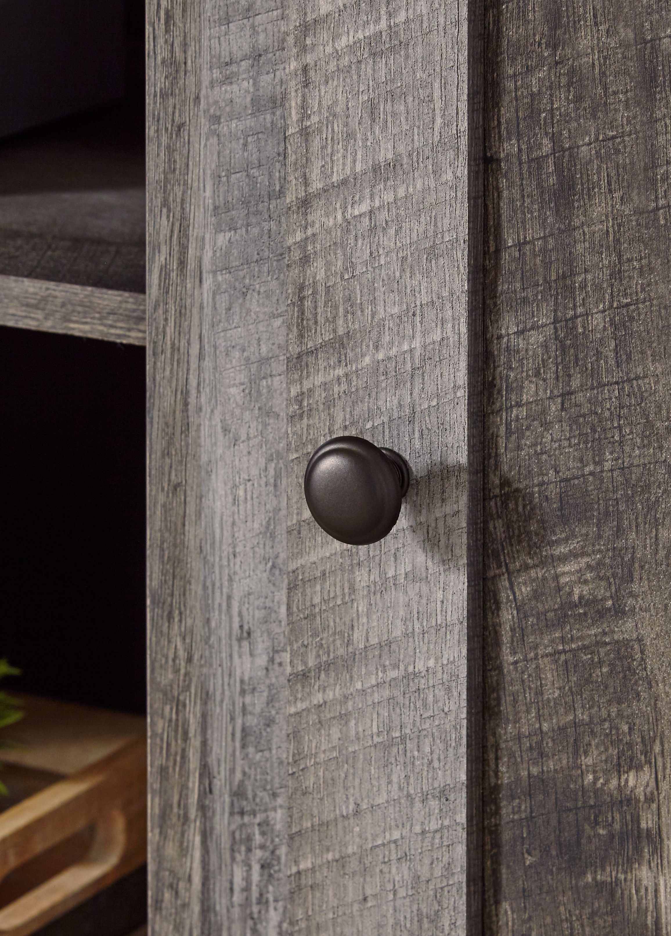 Gray cabinet knob on distressed wood door