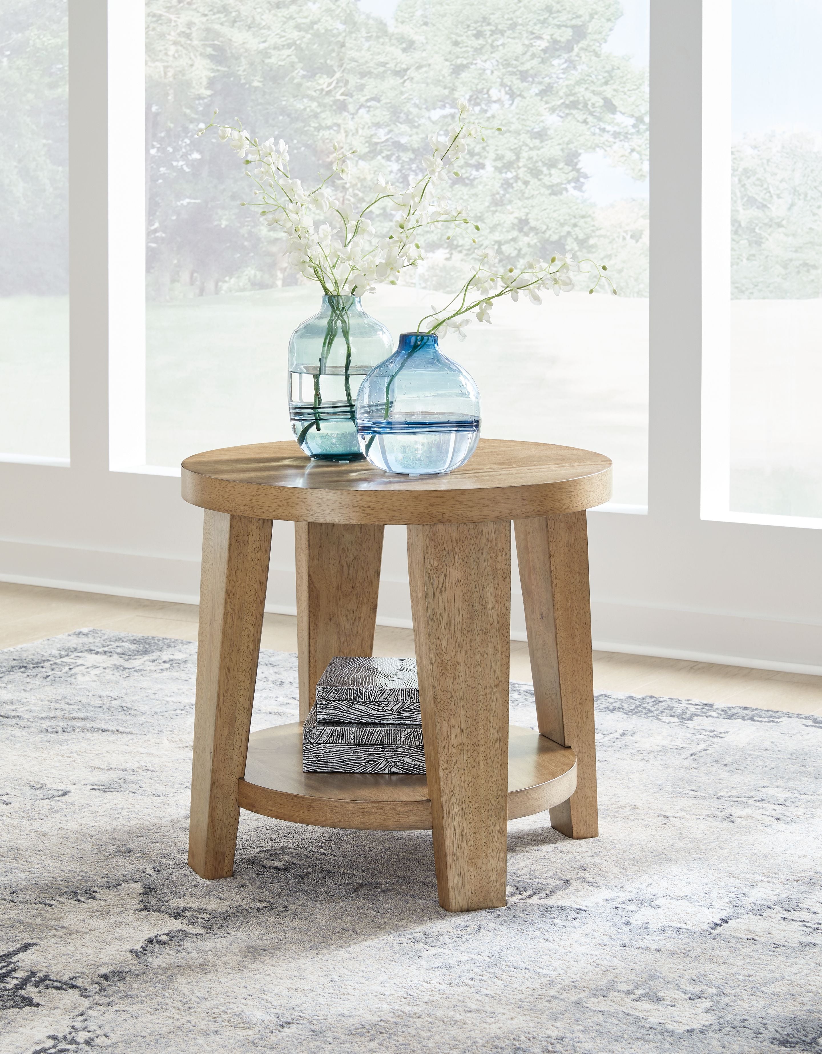 Kristiland light brown round end table with two-tier design and four tapered legs