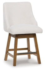 Upholstered barstool in oatmeal fabric with rounded seat and light brown legs