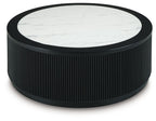 Black ribbed round table with white marble-look top and dark outer rim