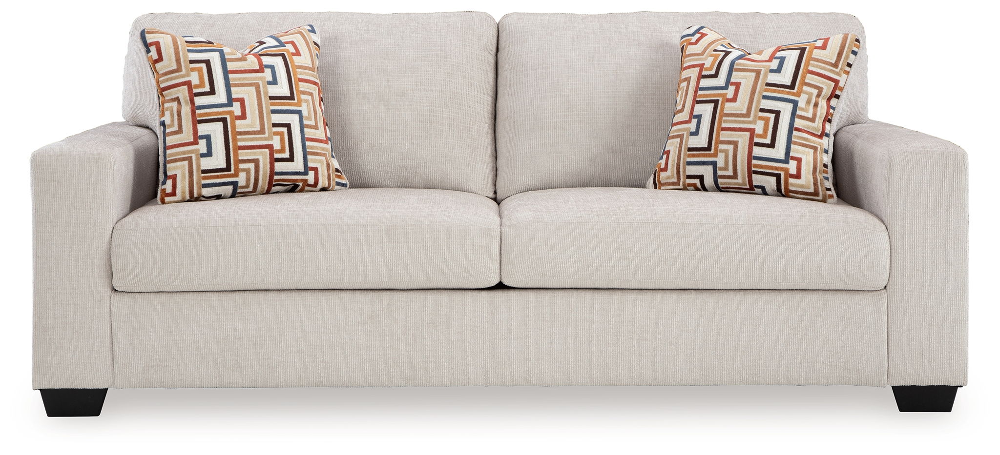 Light beige upholstered sofa with two patterned geometric throw pillows.