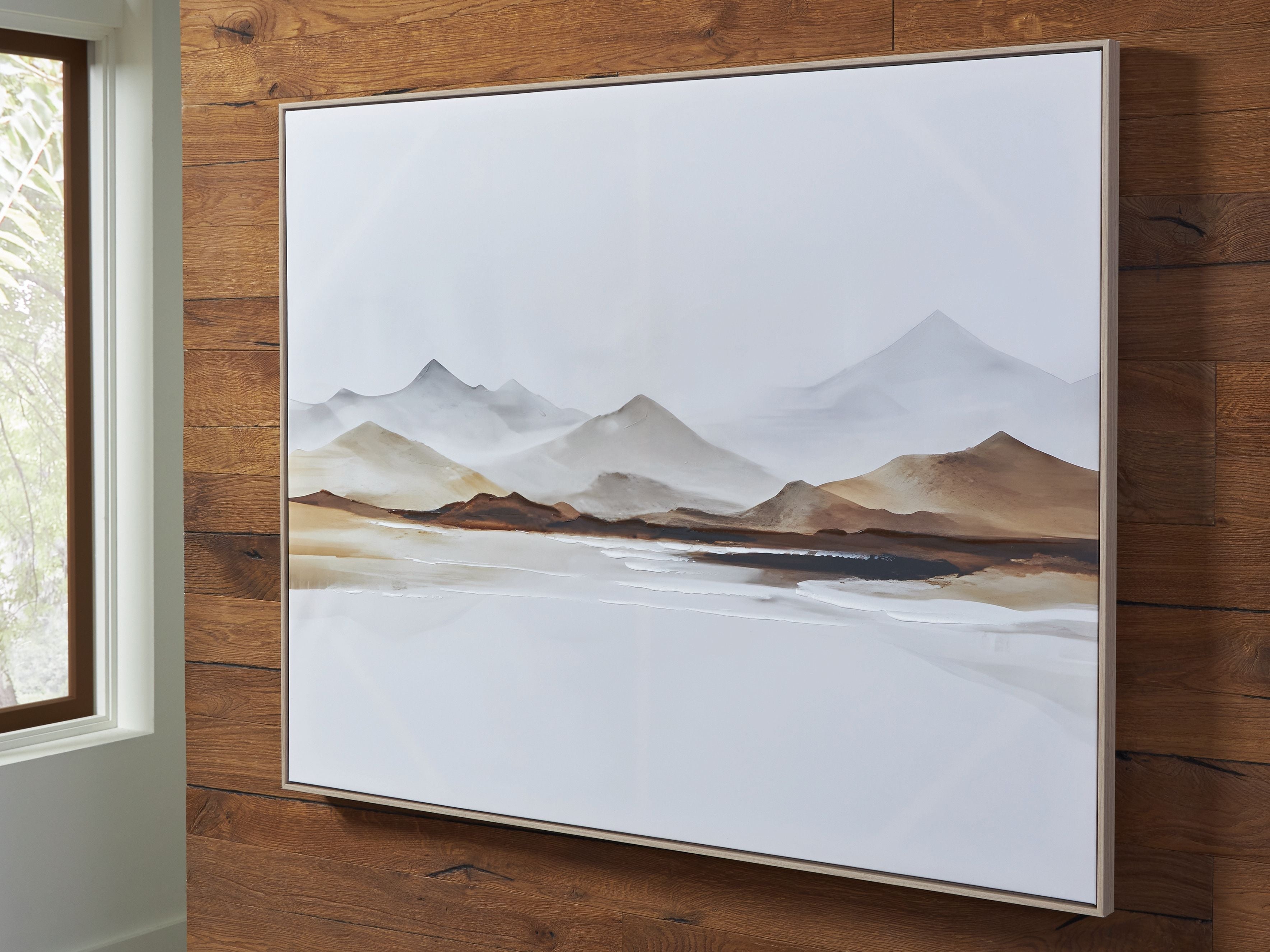 Framed mountain landscape wall art with misty peaks and warm brown horizon