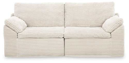 Ivory corduroy corner chair with two seat cushions and button-tufted arms