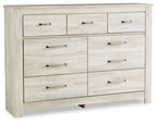 Light brown wooden dresser with six drawers and dark metal bar pulls