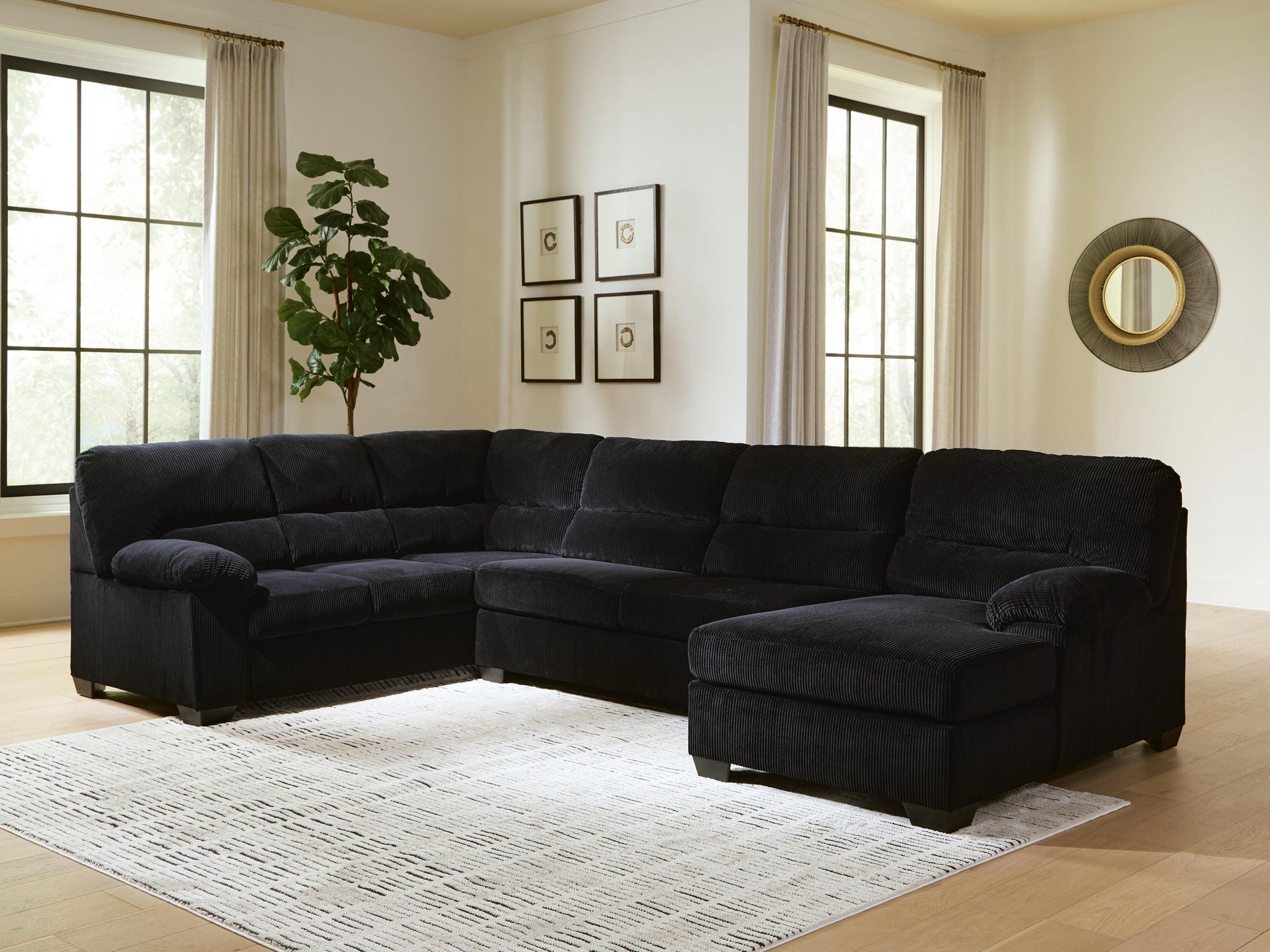 Dark sectional sofa with corner chaise, tufted cushions, wide arms, plush fabric