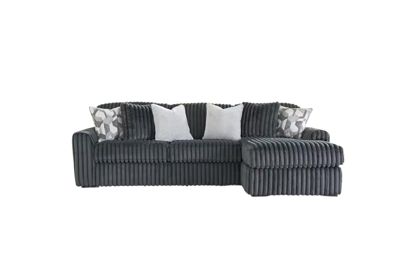 Charcoal sectional sofa with chaise extension and geometric-pattern throw pillows.