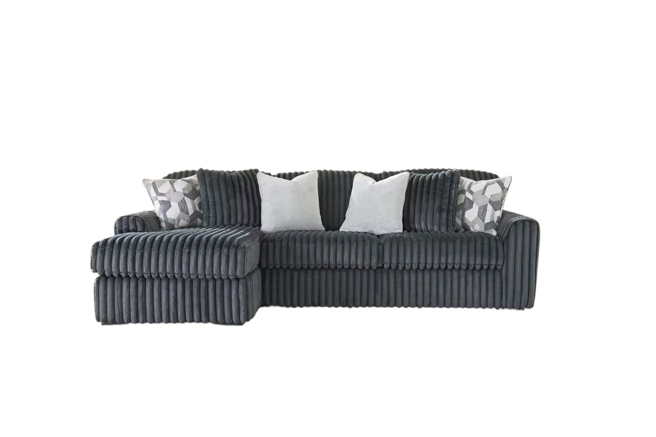 Charcoal sectional sofa with corner chaise and multiple striped throw pillows and back cushions.