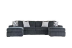 Charcoal sectional sofa with chaise-style side and geometric throw pillows.