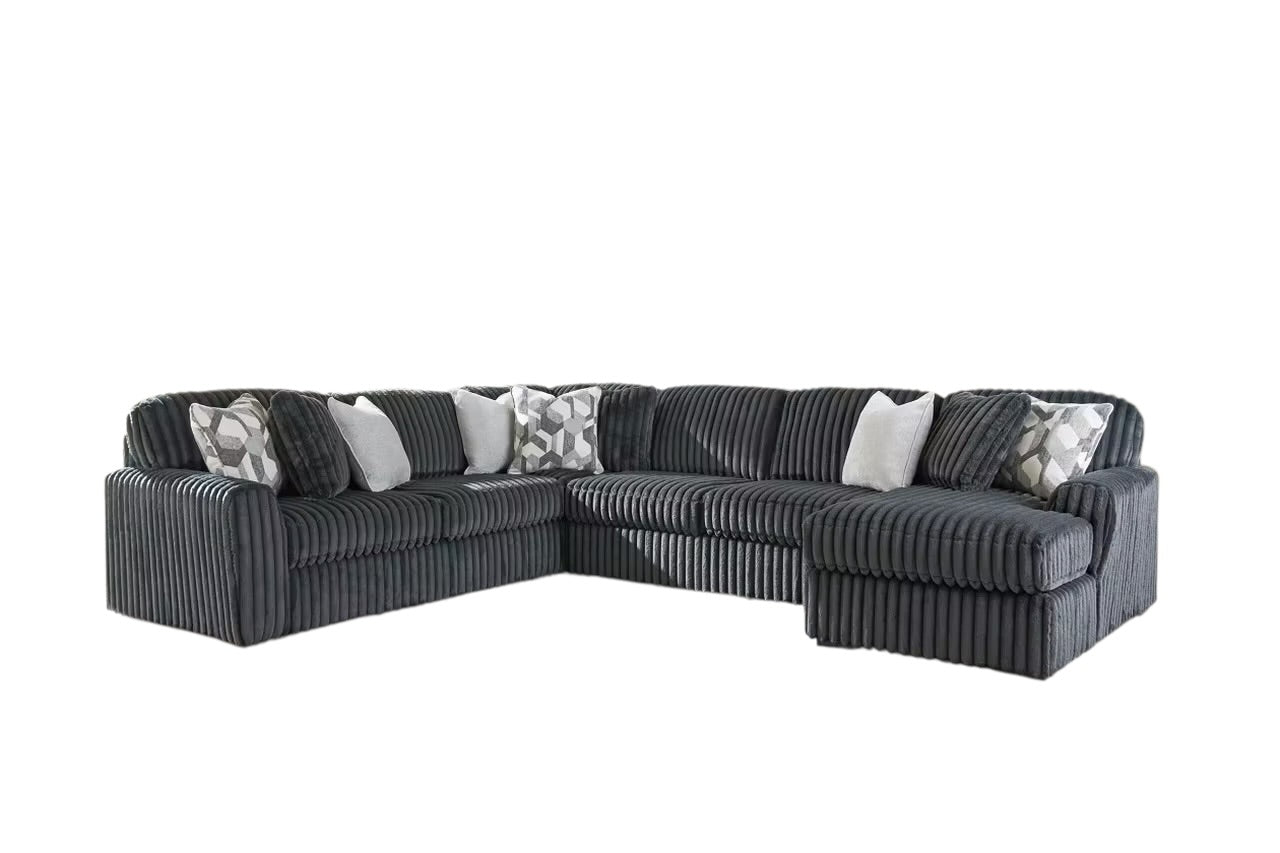 Charcoal U-shaped sectional sofa with chaise ends and geometric-pattern throw pillows.