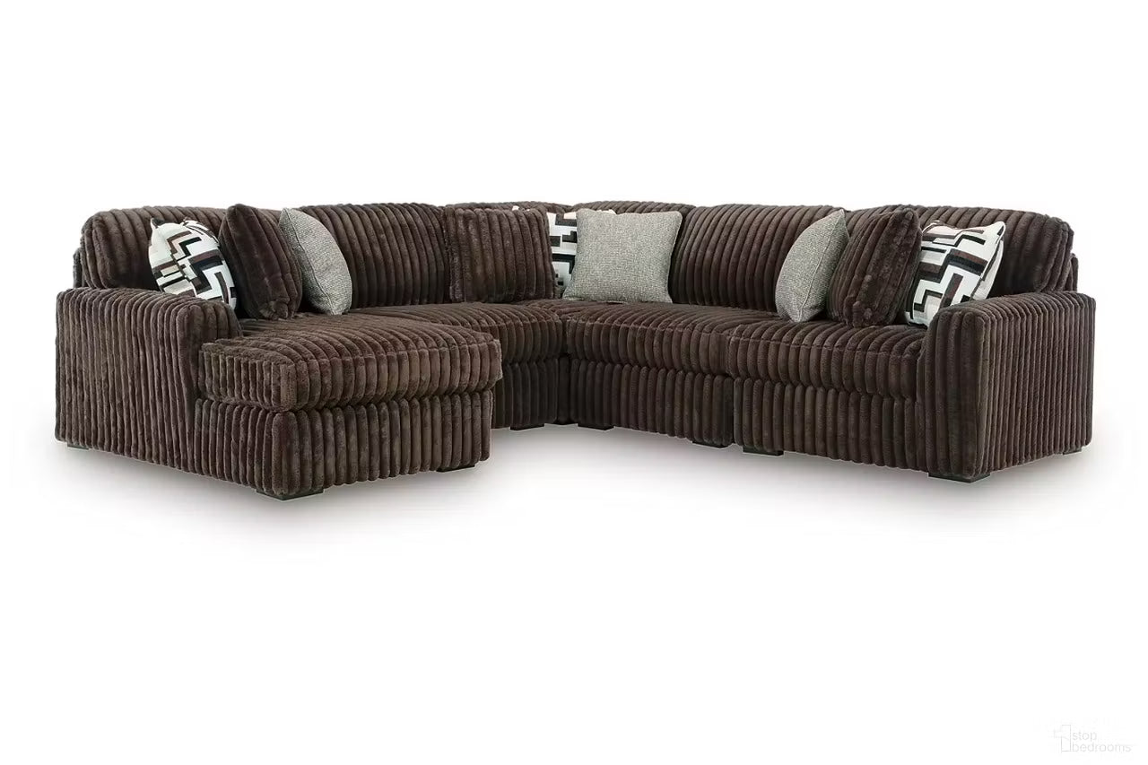 Brown corduroy sectional sofa with corner chaise and patterned accent pillows