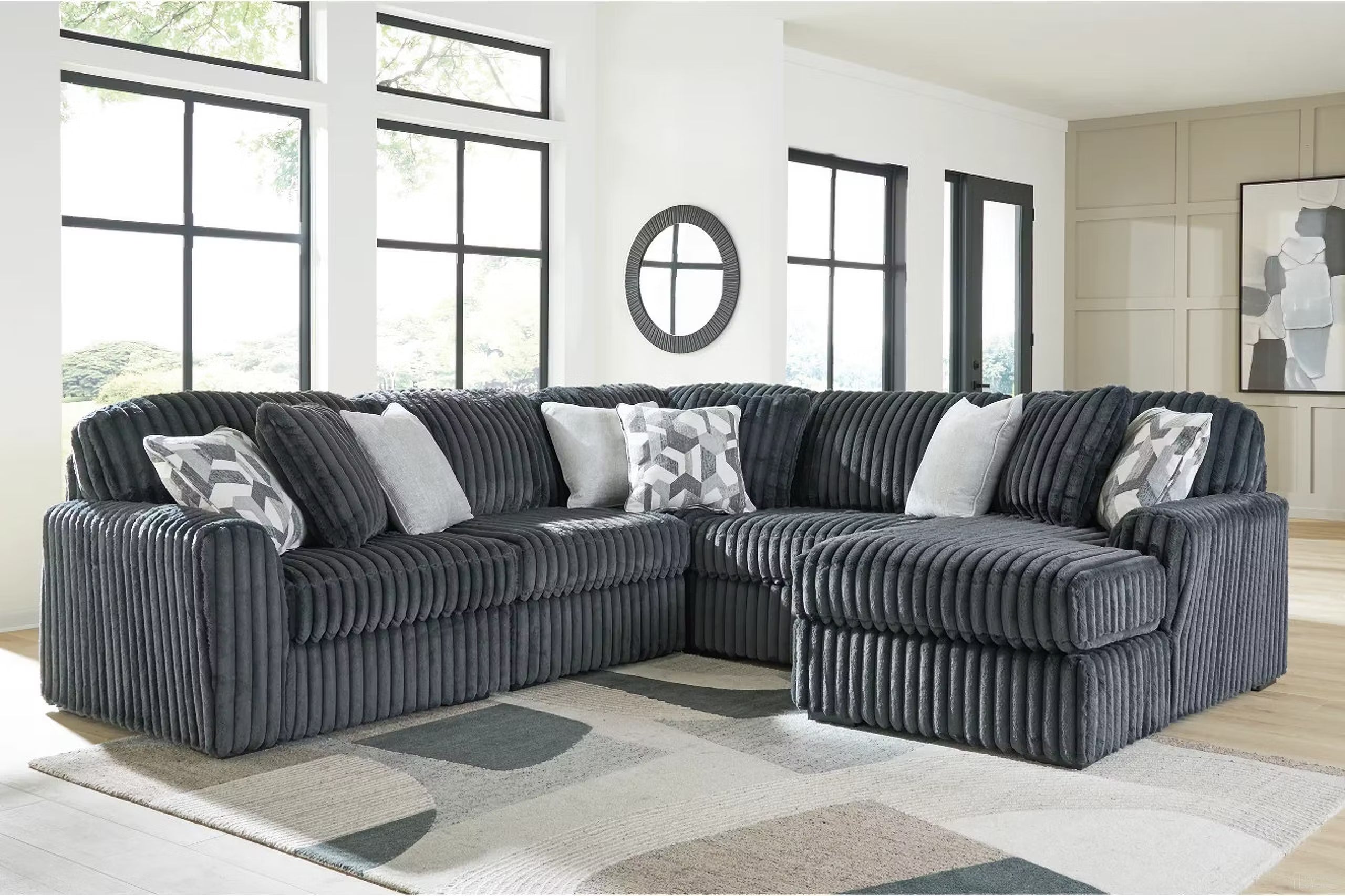 Blue-gray corduroy sectional sofa with corner chaise and patterned pillows