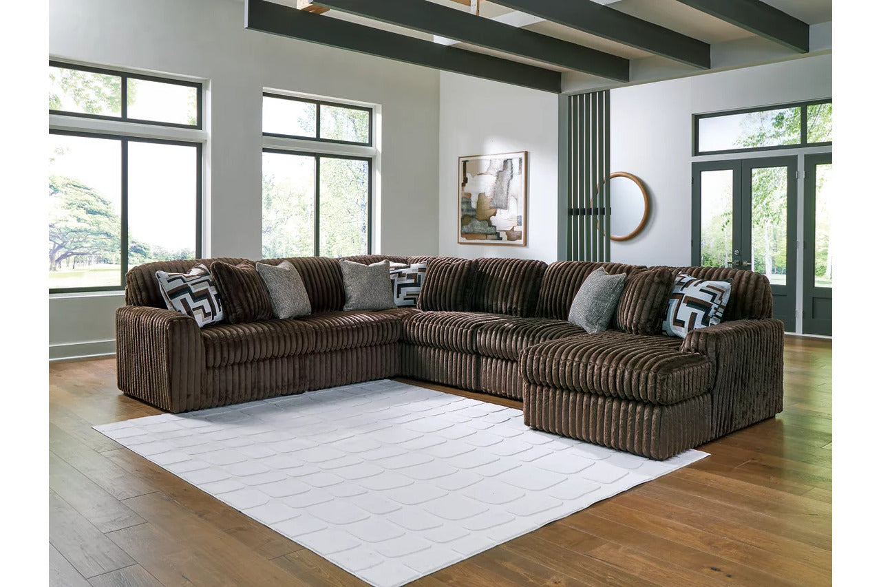 Sectional sofa with chaise, brown corded upholstery and patterned accent pillows