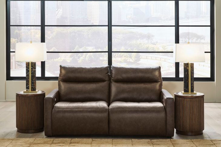 Chocolate power reclining sofa with tufted back cushions and padded arms