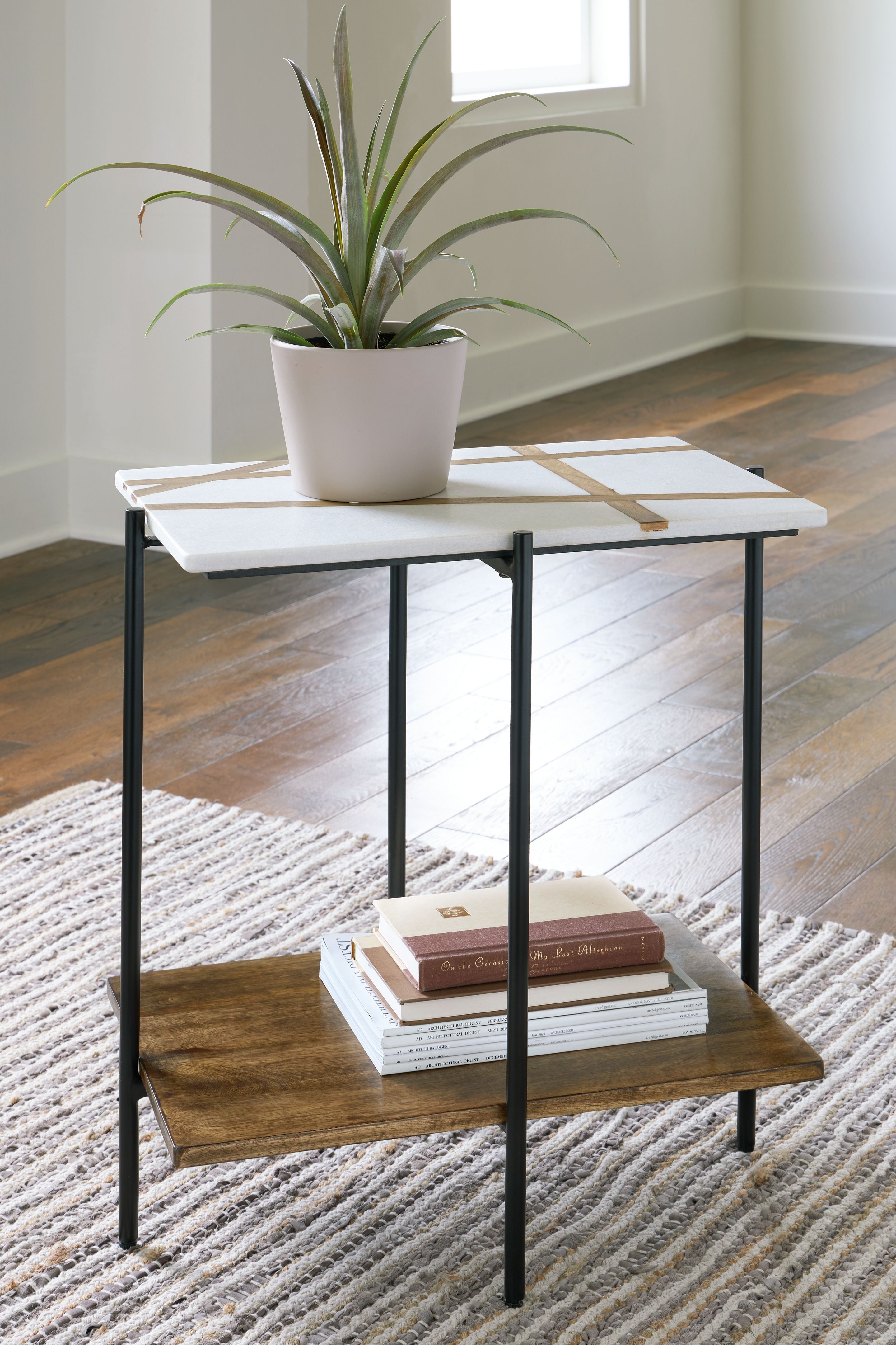 Accent table with white top, black metal frame, and light brown lower shelf.