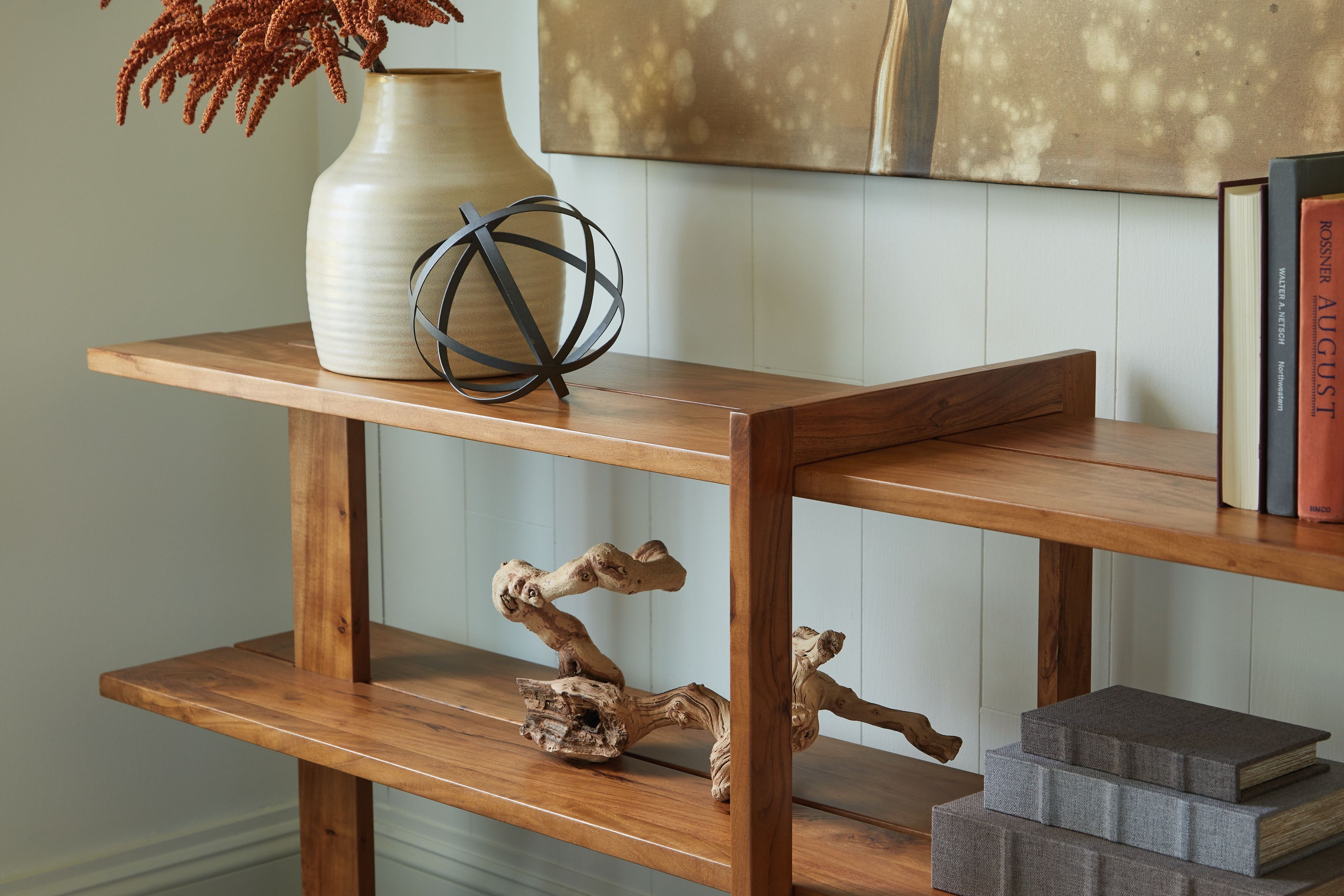 Brown wood console sofa table with two open shelves and sturdy angled legs.