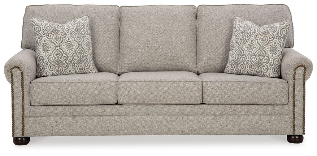 Queen sofa sleeper in light gray fabric with two patterned accent pillows and rolled arms