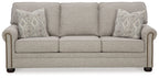Queen sofa sleeper in light gray fabric with two patterned accent pillows and rolled arms