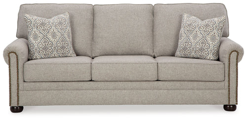 Queen sofa sleeper in light gray fabric with two patterned accent pillows and rolled arms