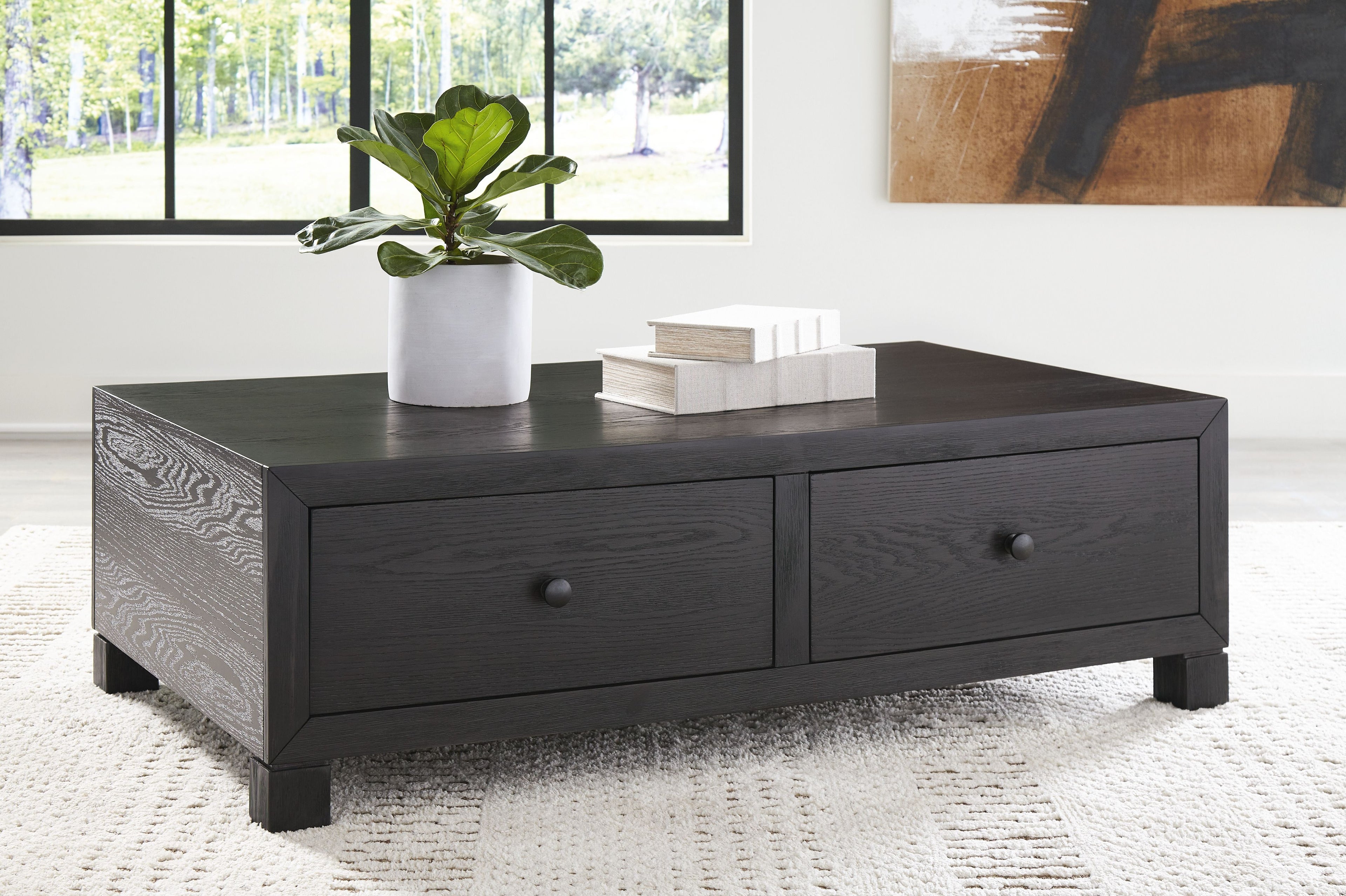 Dark wood cocktail table with two storage drawers and turned feet, rectangular top