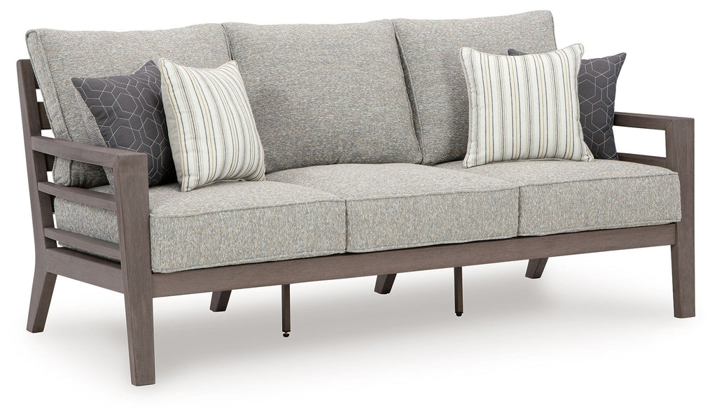 Gray outdoor sofa with three back cushions and two striped throw pillows